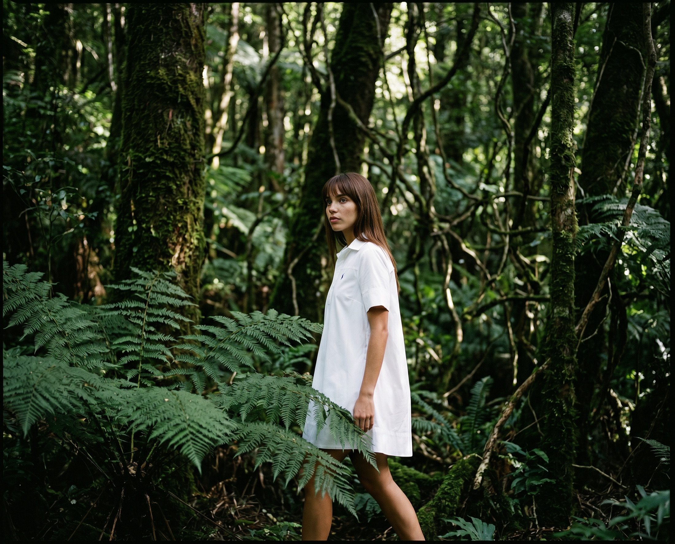 Ralph Lauren lifestyle campaign — model in a white cotton dress walking through a sunlit rainforest