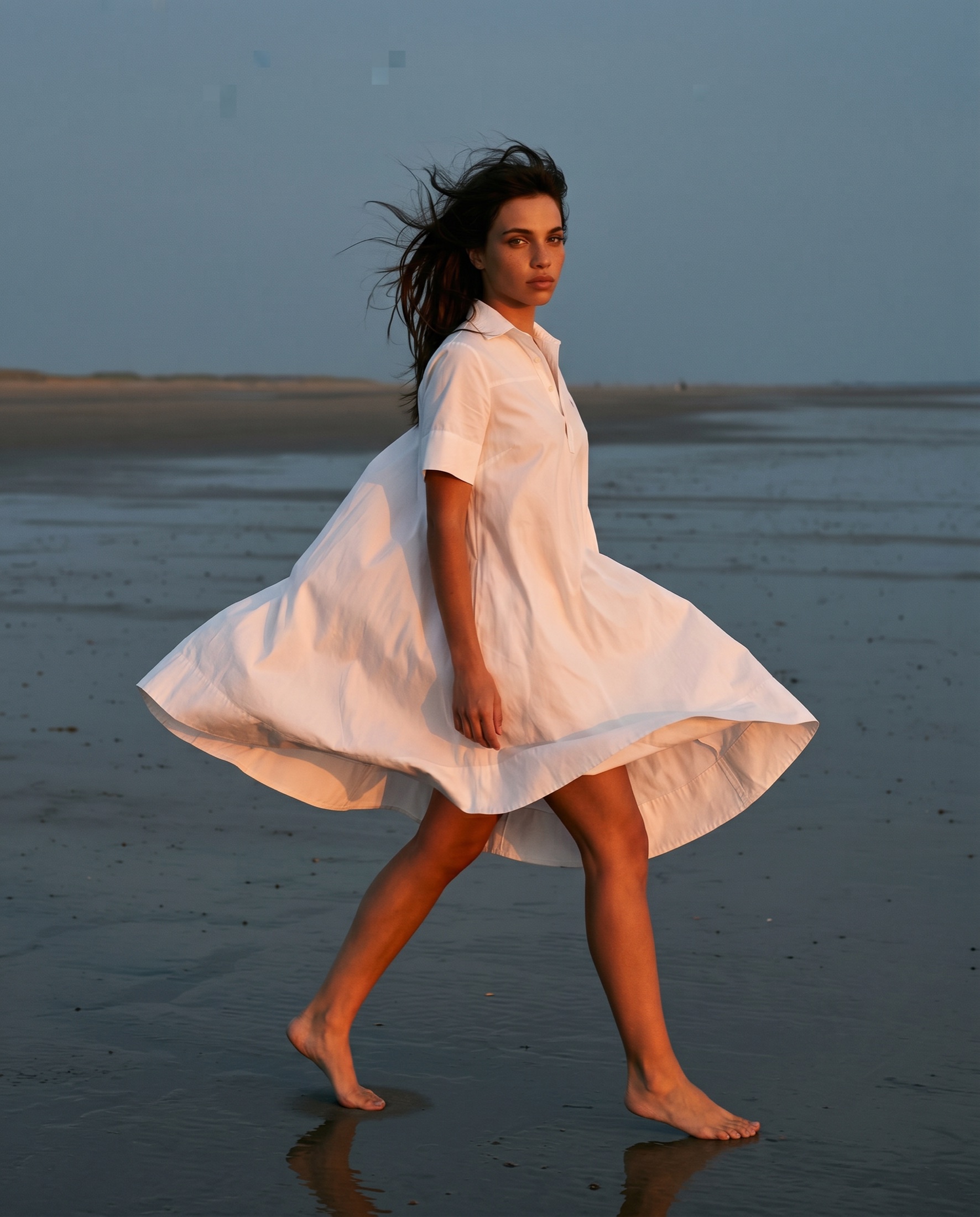 Ralph Lauren lifestyle campaign — white shirt dress in motion on the shoreline at golden hour